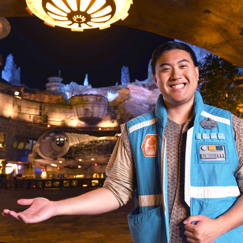 young male employee in costume at a Star Wars attraction in a Disney park, smiling