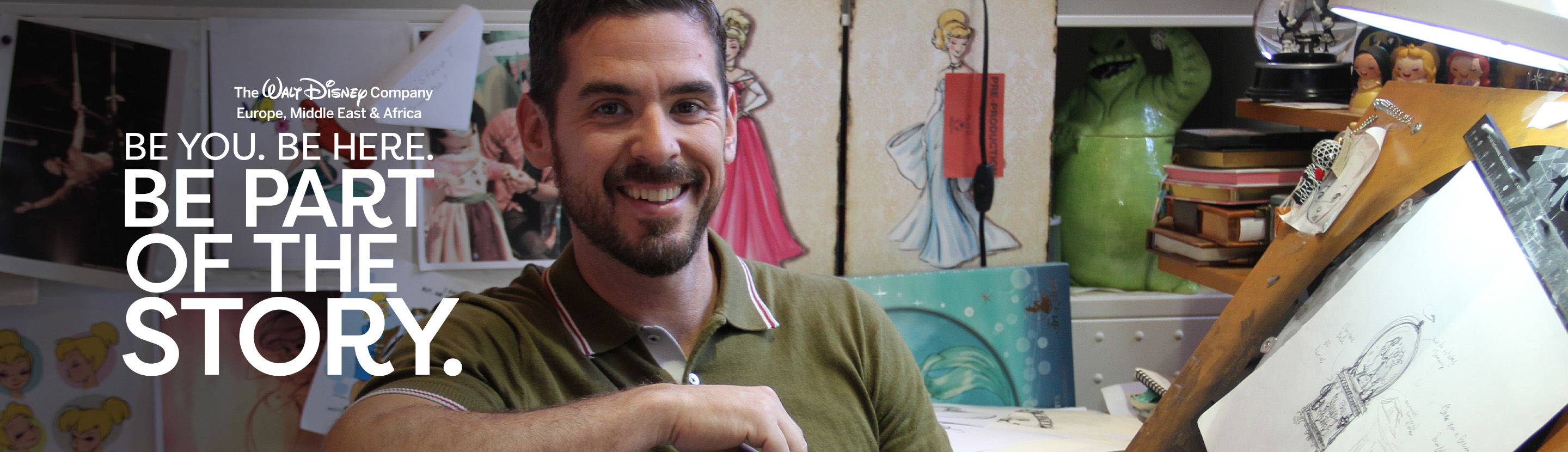 Creative professional working in a design studio featuring Disney character sketches and artwork displays