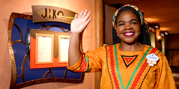 Cast member smiling and waving at Walt Disney World.