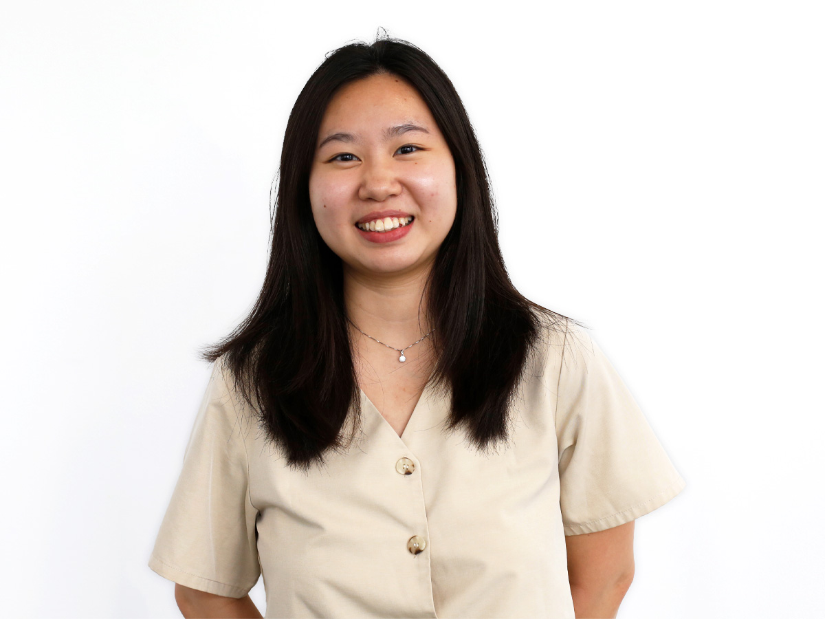 Singapore intern, Audrey has black hair and is smiling in front of a background of the Disney store website
