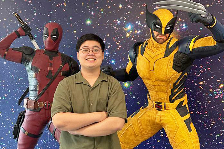 The Walt Disney Company intern Joshua smiling while standing in front of Deadpool and Wolverine characters