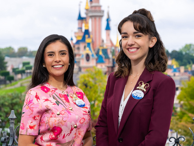 Two smiling women with the Disneyland Paris castle in the background