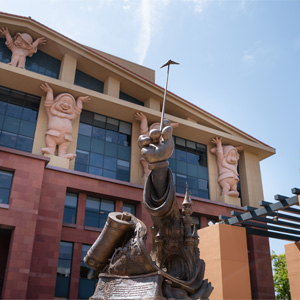 Disney Legends Plaza featuring the Partners statue and Seven Dwarfs sculptures on the Michael D. Eisner Building