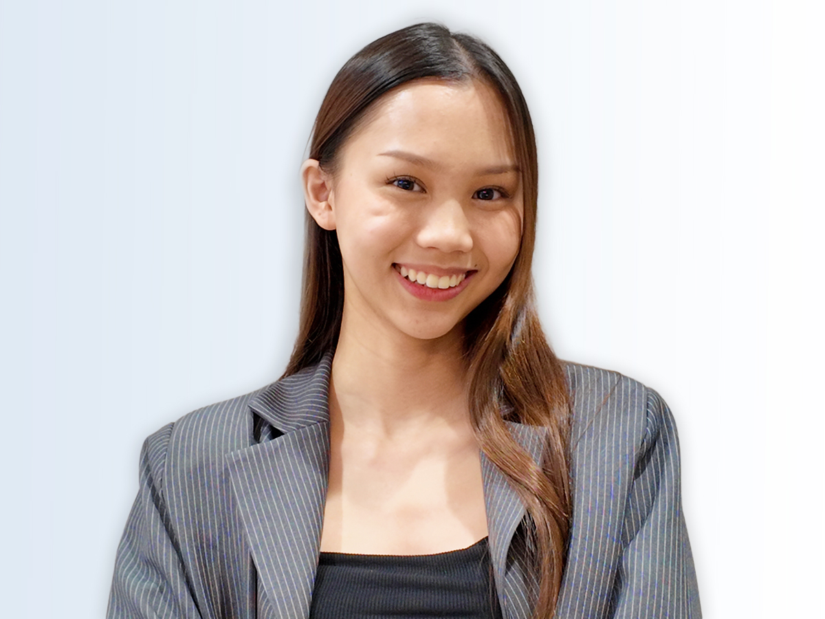 The Walt Disney Company Asia intern Joamai smiling with long brown hair, wearing a grey pinstriped blazer