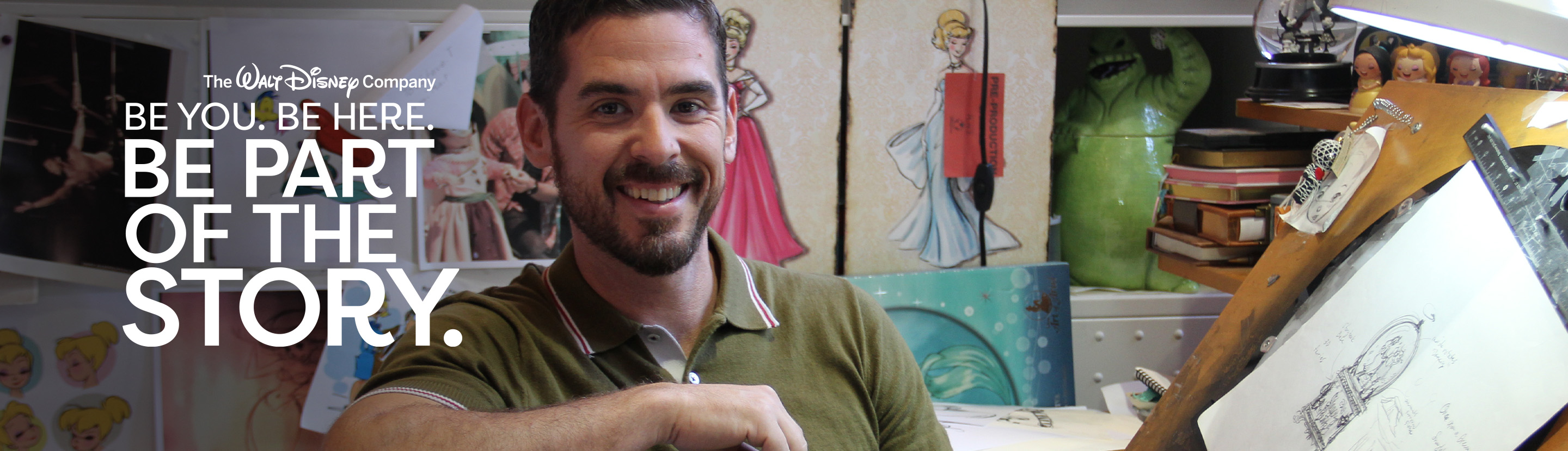 Creative professional working in a design studio featuring Disney character sketches and artwork displays