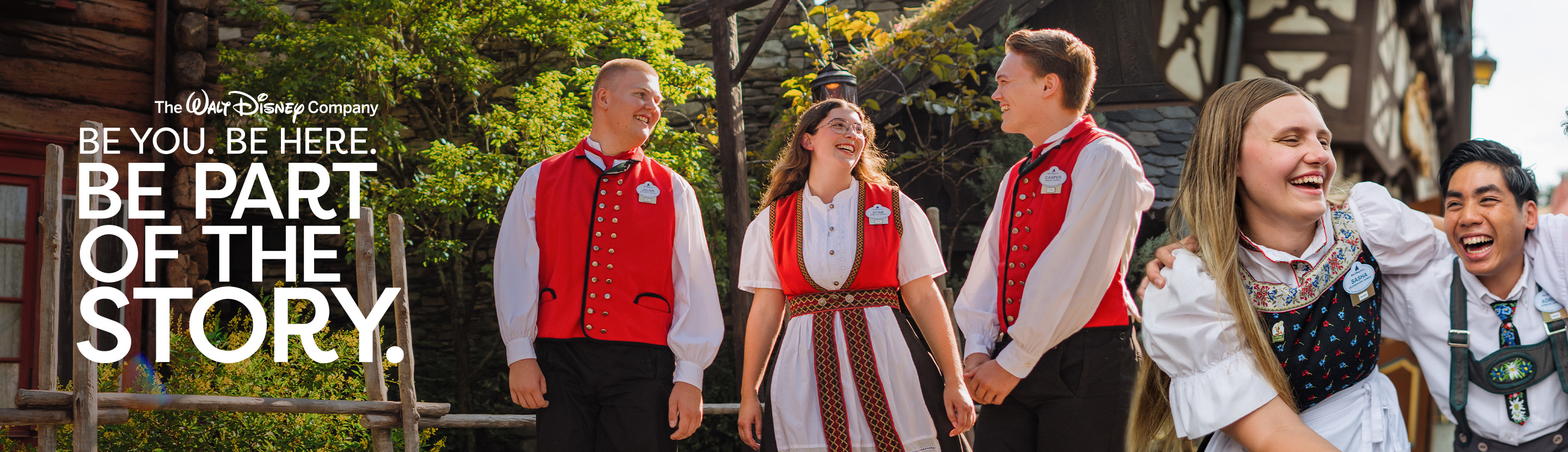 Three program participants walking through the Norway pavilion near traditional Norwegian-inspired architecture