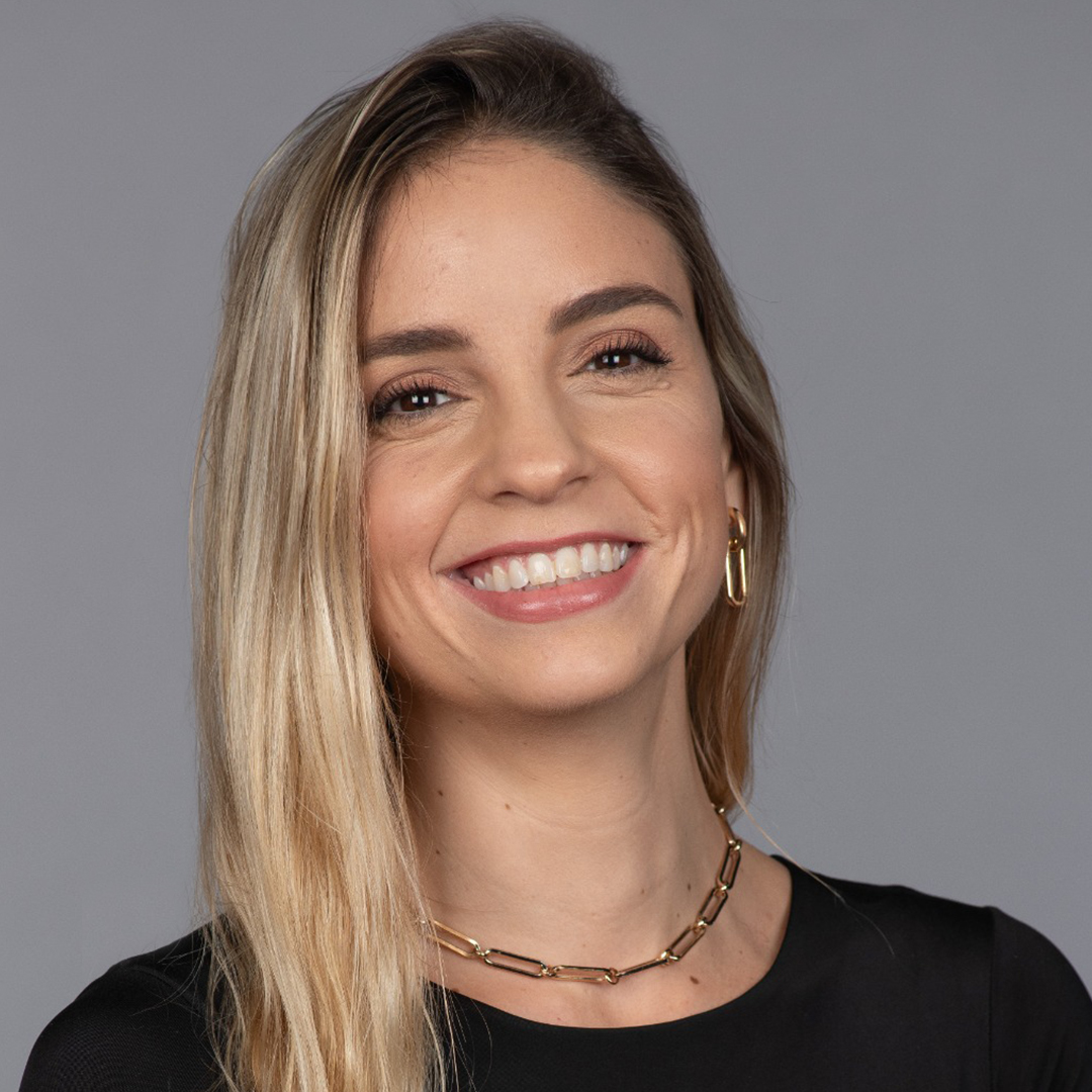The Walt Disney Company Latin America Talent Acquisition Manager Delfina wearing a black shirt and gold necklace smiling with long blonde hair