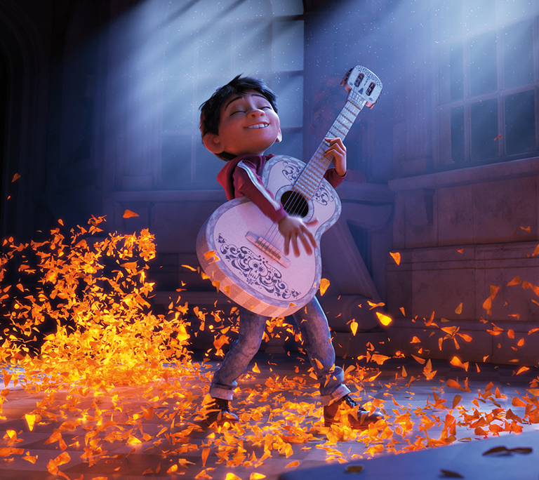 Miguel from the Disney movie Coco strumming a guitar with glowing leaves at his feet