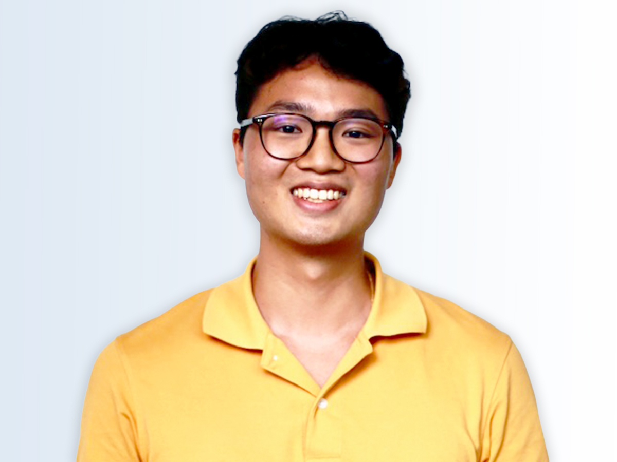 The Walt Disney Company Asia intern Justin wearing glasses and a yellow polo shirt smiling