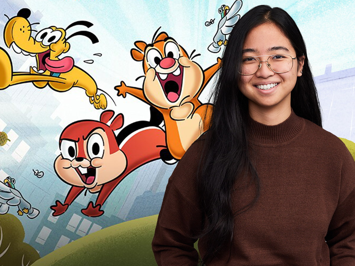 Disney UK Intern Bibechana smiling with long black hair, glasses and a brown sweater. Chip, Dale and Pluto animated characters are in her background.