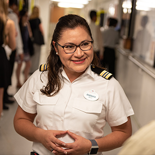 female HR manager in a white uniform, smiling