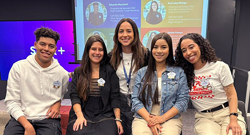 group of interns sitting and smiling