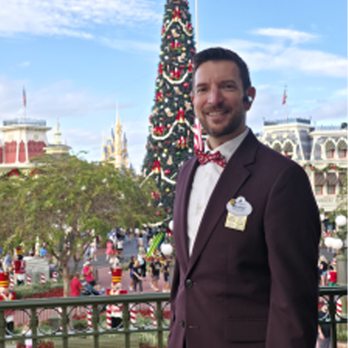 International programs participant standing near holiday decorations and a Christmas tree.