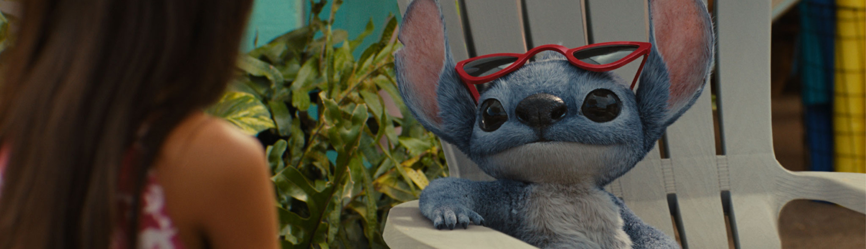 A still from Lilo and Stitch (2025) featuring Stitch with red sunglasses on his head