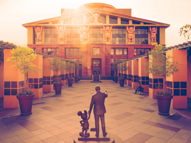 The Partners Statue of Walt Disney and Mickey Mouse during golden hour on The Walt Disney Studios lot