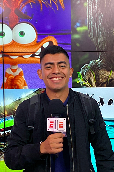 Mexico Apprentice Santiago smiling while holding an ESPN microphone