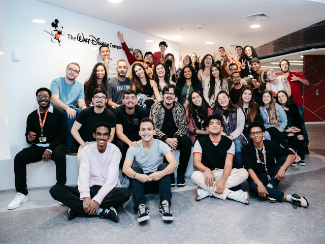 A large, diverse group of interns gathered at The Walt Disney Company Brazil