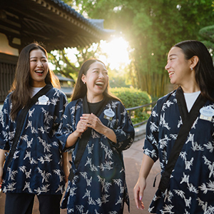 Three women smiling and laughing while working at Walt Disney World together.