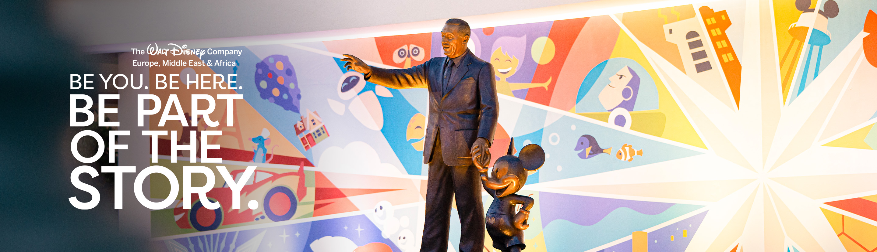 The iconic "Partners" statue in an EMEA office in front of a Pixar inspired mural