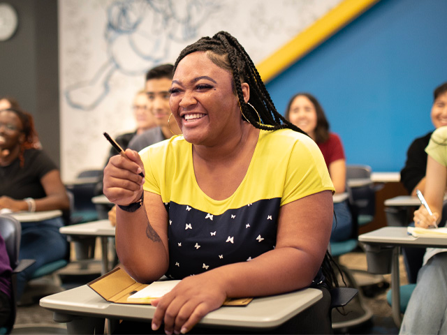 Engaged student smiling in a classroom