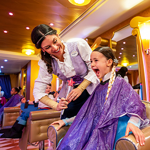 female hotel employee giving an excited female child a Disney princess makeover