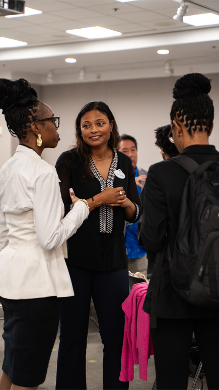 Group of participants engaged in conversation during an outdoor networking event
