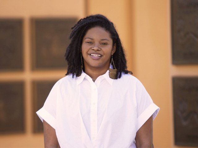 A smiling woman in a white shirt
