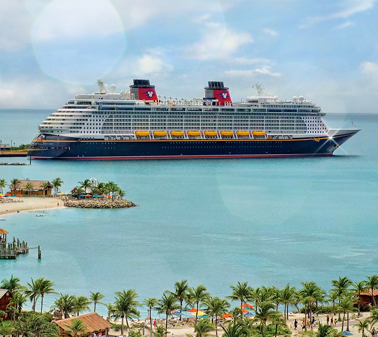 Disney Cruise Line ship sailing away from an island