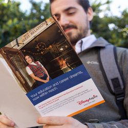 Man reading a brochure about education and career opportunities
