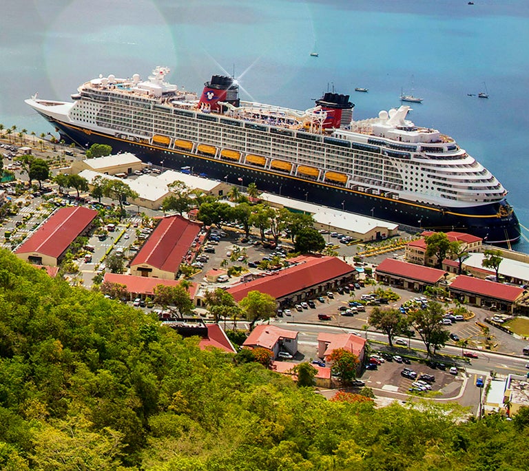 Disney Cruise Line ship alongside the coast of an island