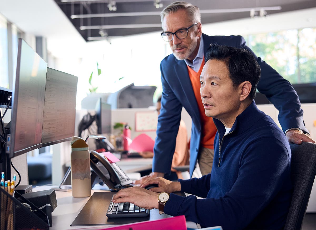 Healthcare decision-makers review information on a computer monitor