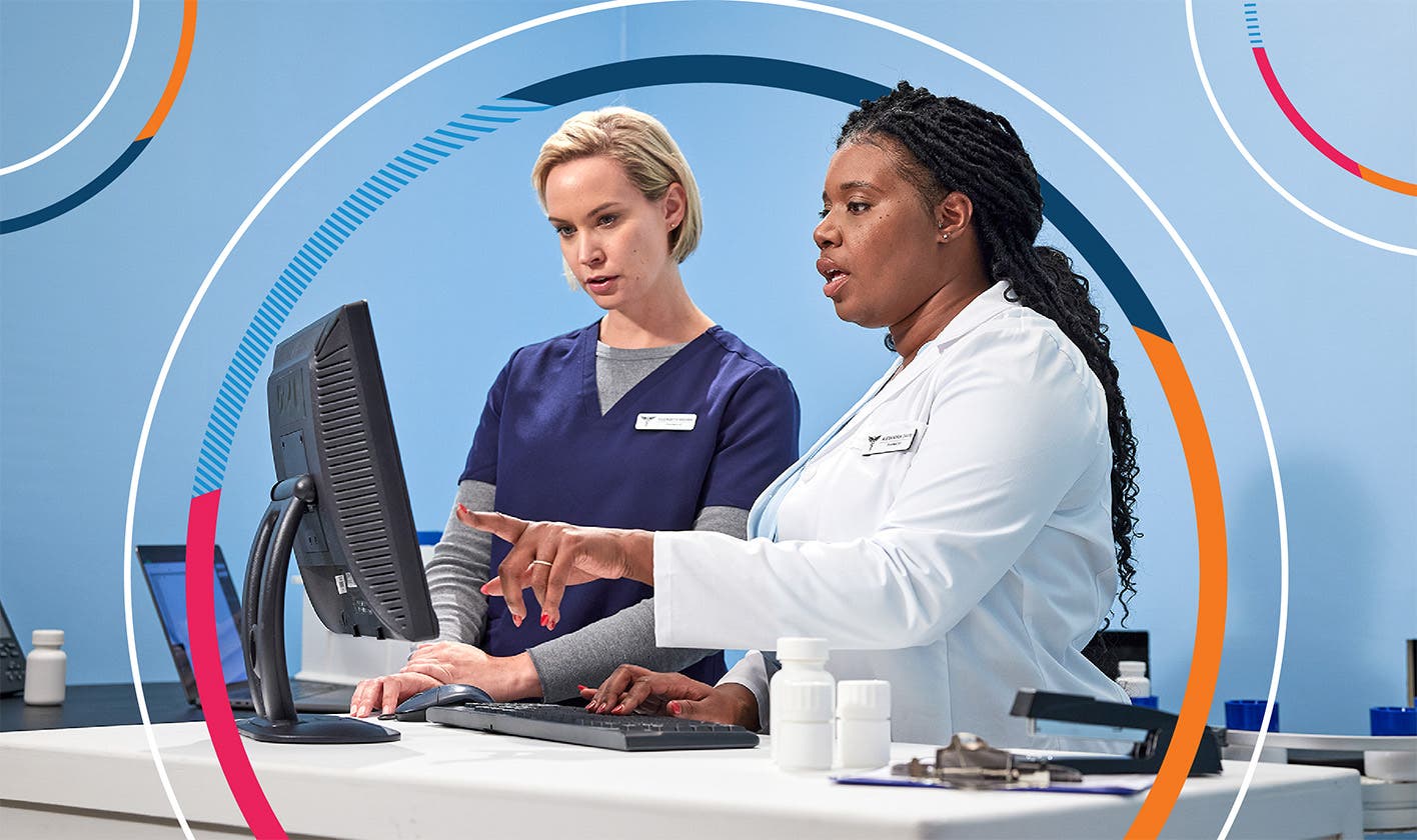 Pharmacists interact with computer