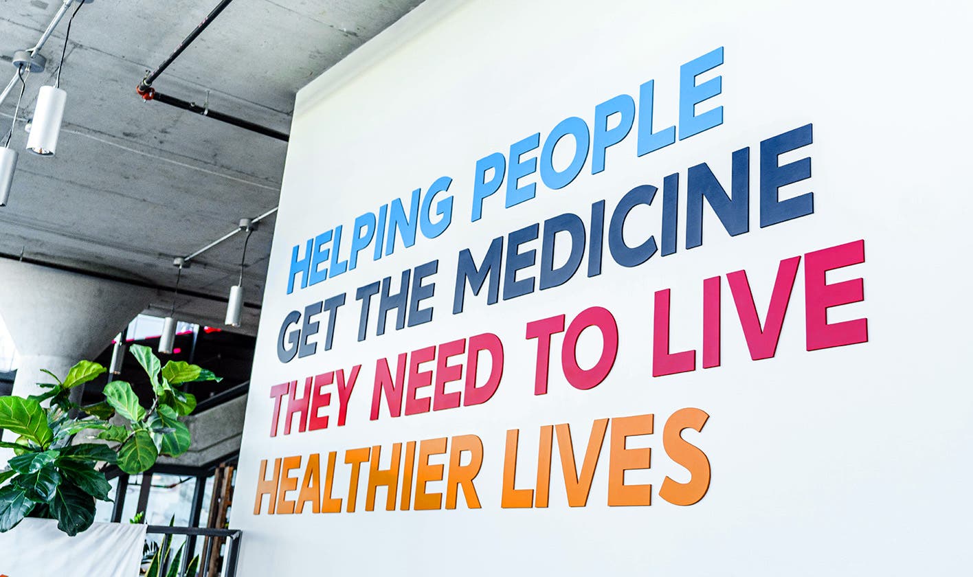 3D lettering on campus wall stating, "Helping people get the medicine they need to live healthier lives"