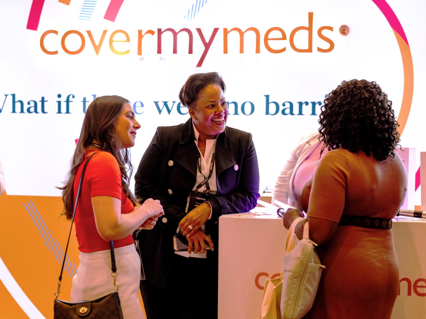 Attendees gather around CoverMyMeds Asembia booth