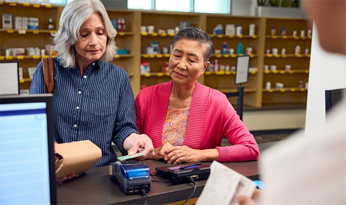 Patient's spouse pays for medication at the pharmacy counter