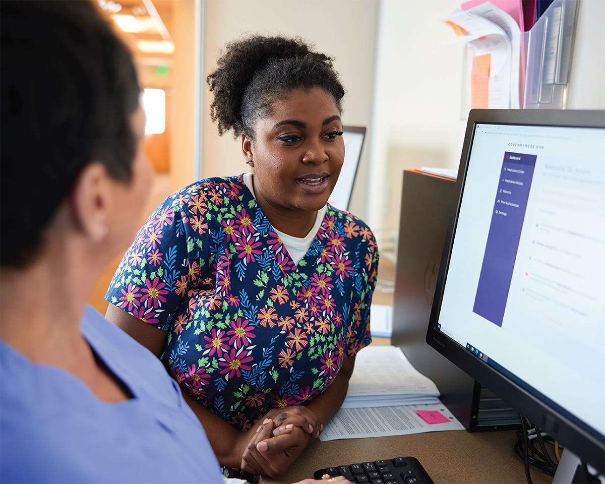 Care team at computer discussing prior authorizations