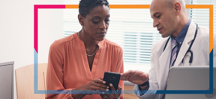 A doctor and a patient looking at a smartphone