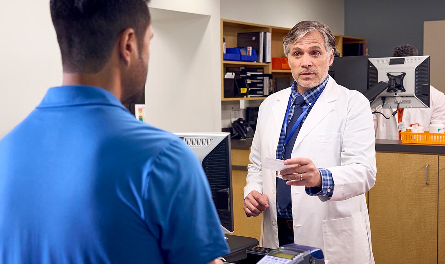 Pharmacist reviewing copay card