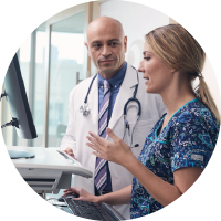 A doctor and a nurse collaborating at an EHR work station