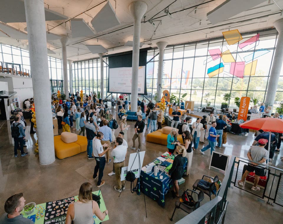 A team of people mingling in a large room
