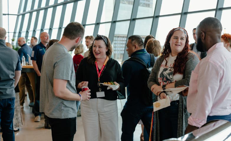 A handful of employees networking together over snacks