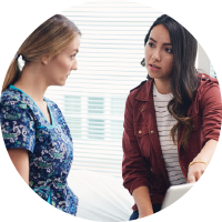 A patient and a nurse reviewing something on a computer together