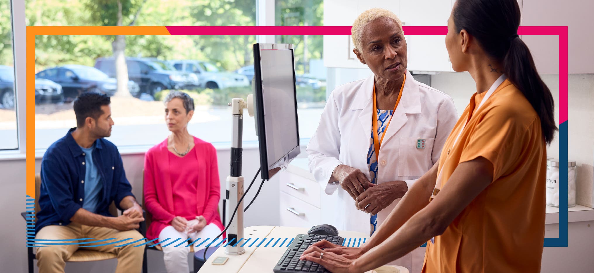 Provider and Care team review prior authorization on the computer with patient and caregiver seated in the background