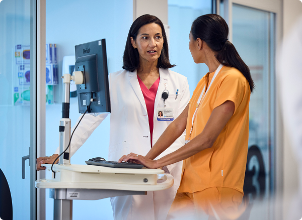 Doctor consulting with nurse at a computer