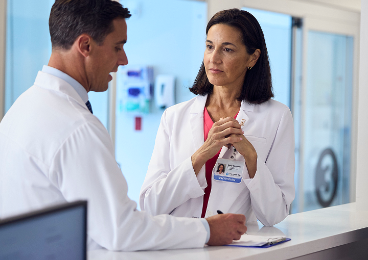Two providers speaking with each other in a care setting