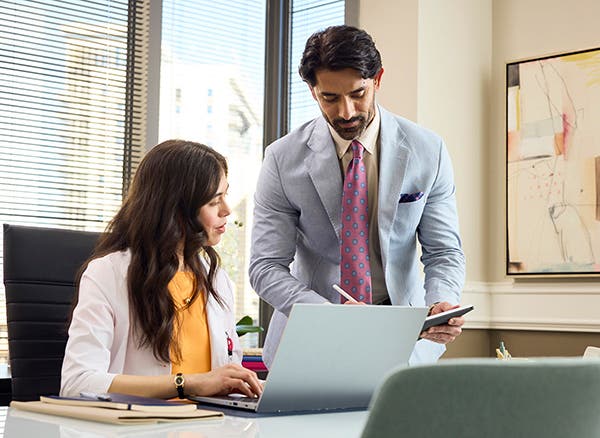 A corporate employee consulting with a provider in her office.