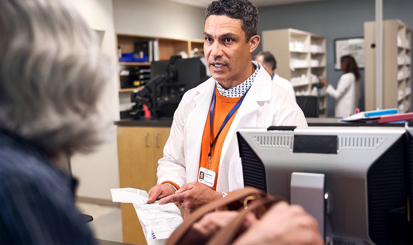 Pharmacist advising patient at the pharmacy counter